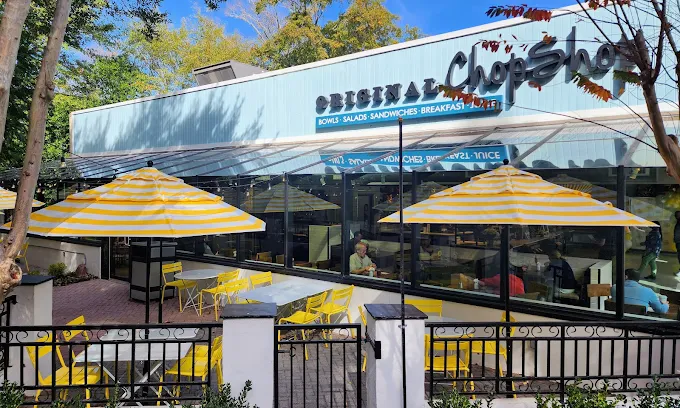 Outdoor seating with yellow umbrellas at Original ChopShop Buckhead Atlanta.