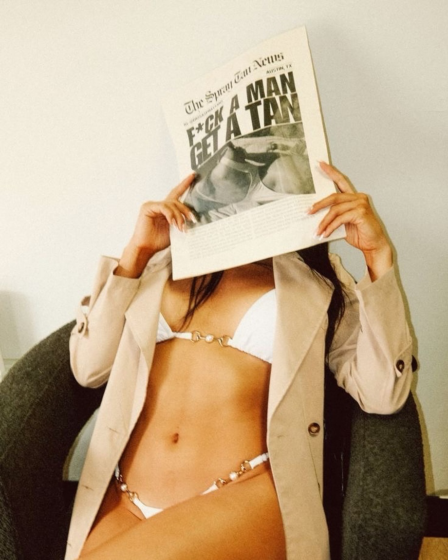 Fashion portrait; person with open shirt holding newspaper, subtle bronze tan – Muse Tan Atelier South End Charlotte