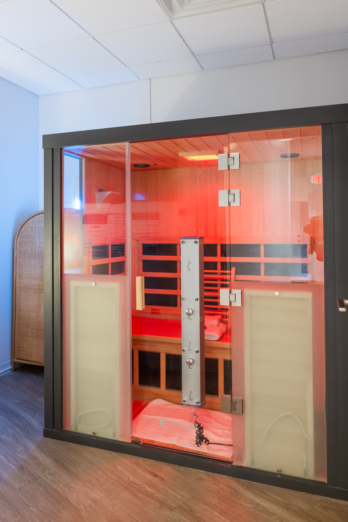 Full-spectrum infrared sauna suite glowing red at Rest + Fuel Buckhead Atlanta