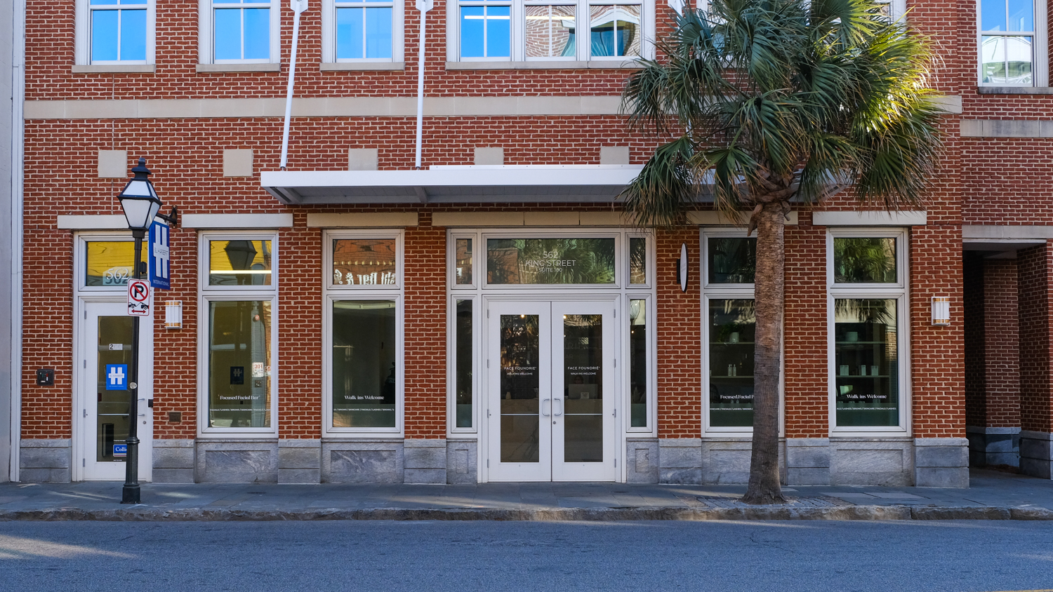 Exterior of FACE FOUNDRIÉ Charleston – Mount Pleasant with teal logo on red-brick building.