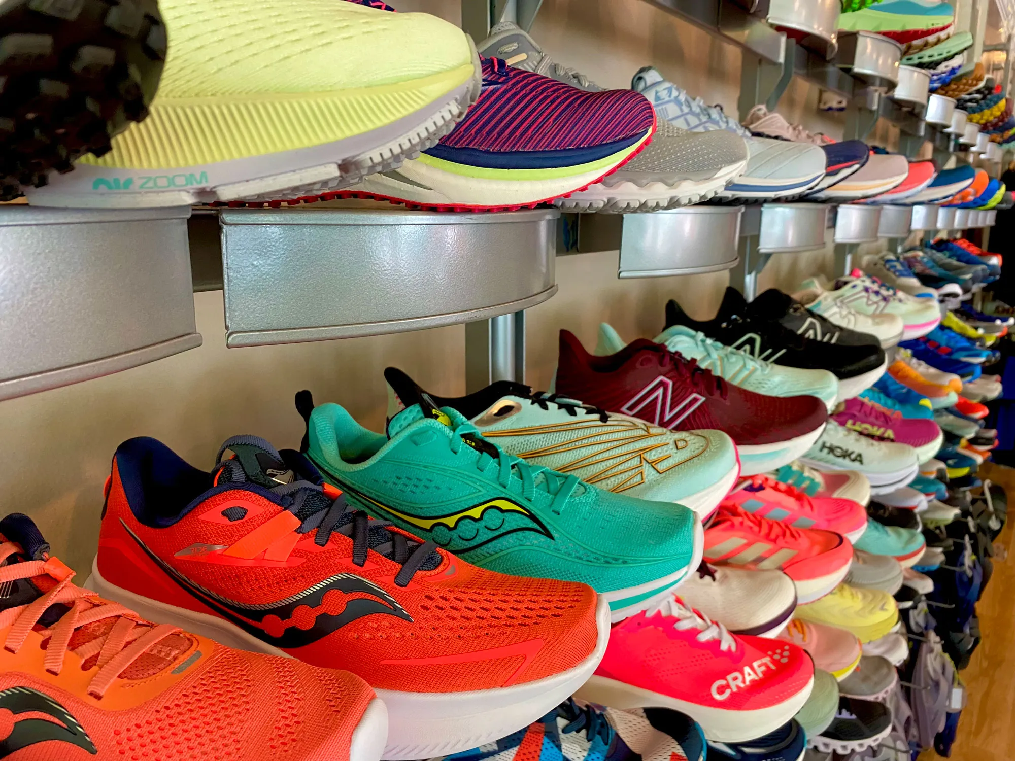 Vibrant display of men’s and women’s running shoes at Fleet Feet Decatur Atlanta store.