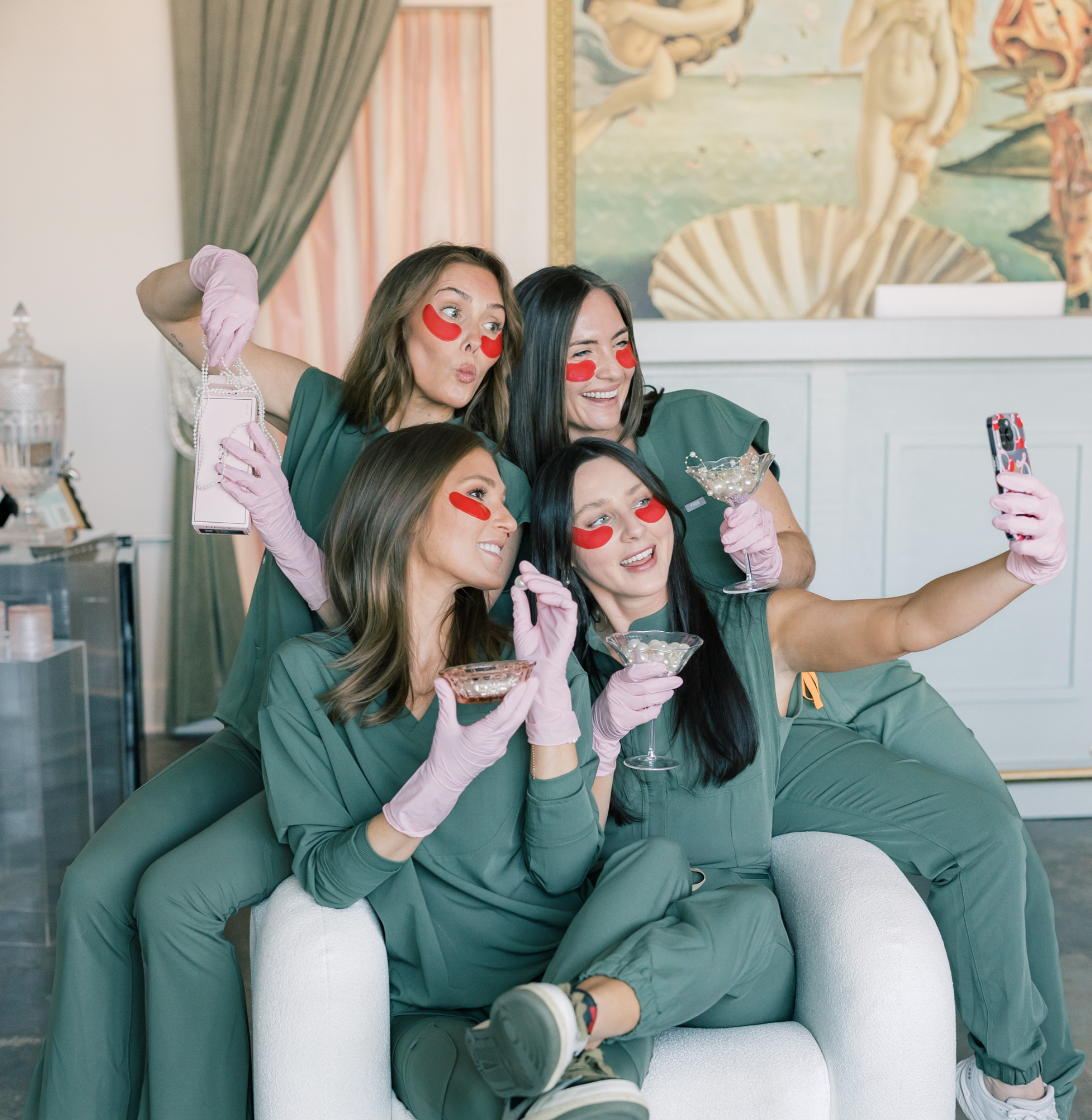 Guests taking a selfie in the lounge area at Pearl Medspa Charleston.