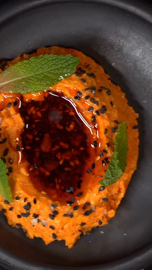 Red pepper dip topped with chili oil, black sesame, and mint at Beso Buckhead.
