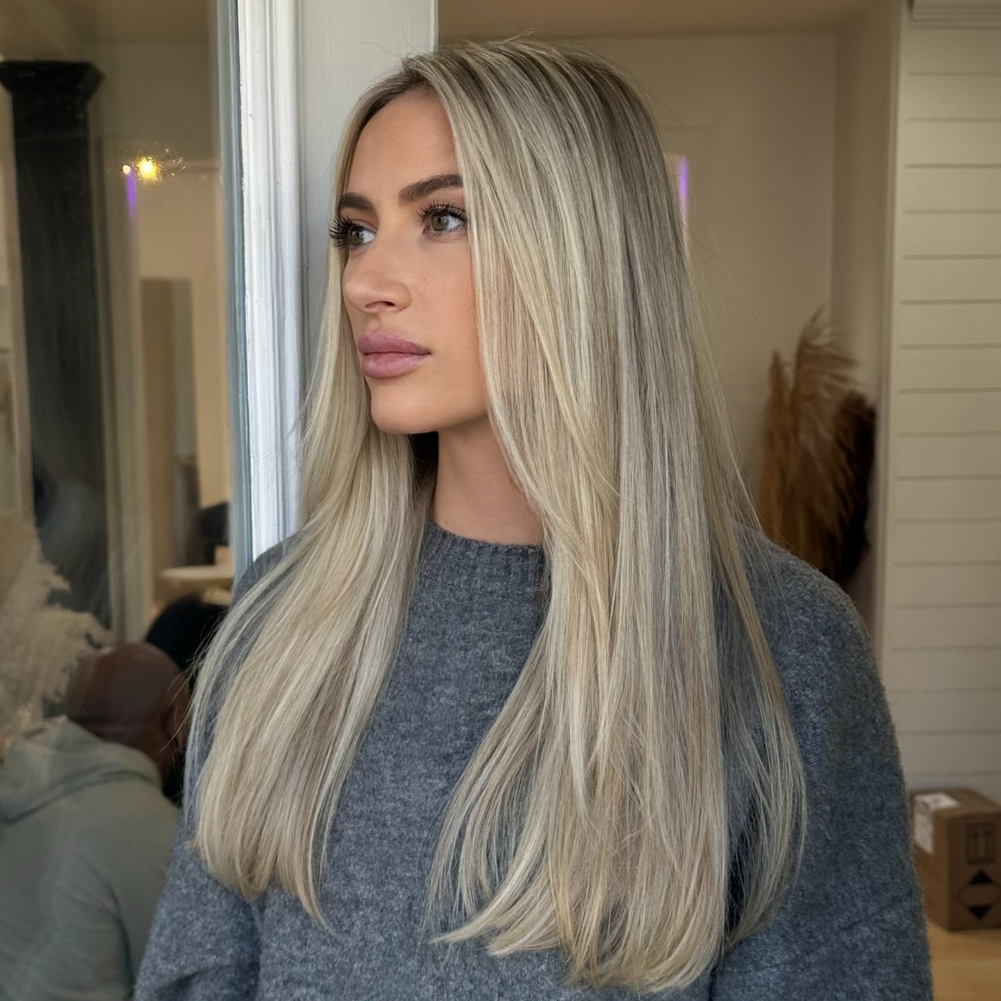 Platinum-blonde long hair blowout on client inside Kayleigh Aesthetics.