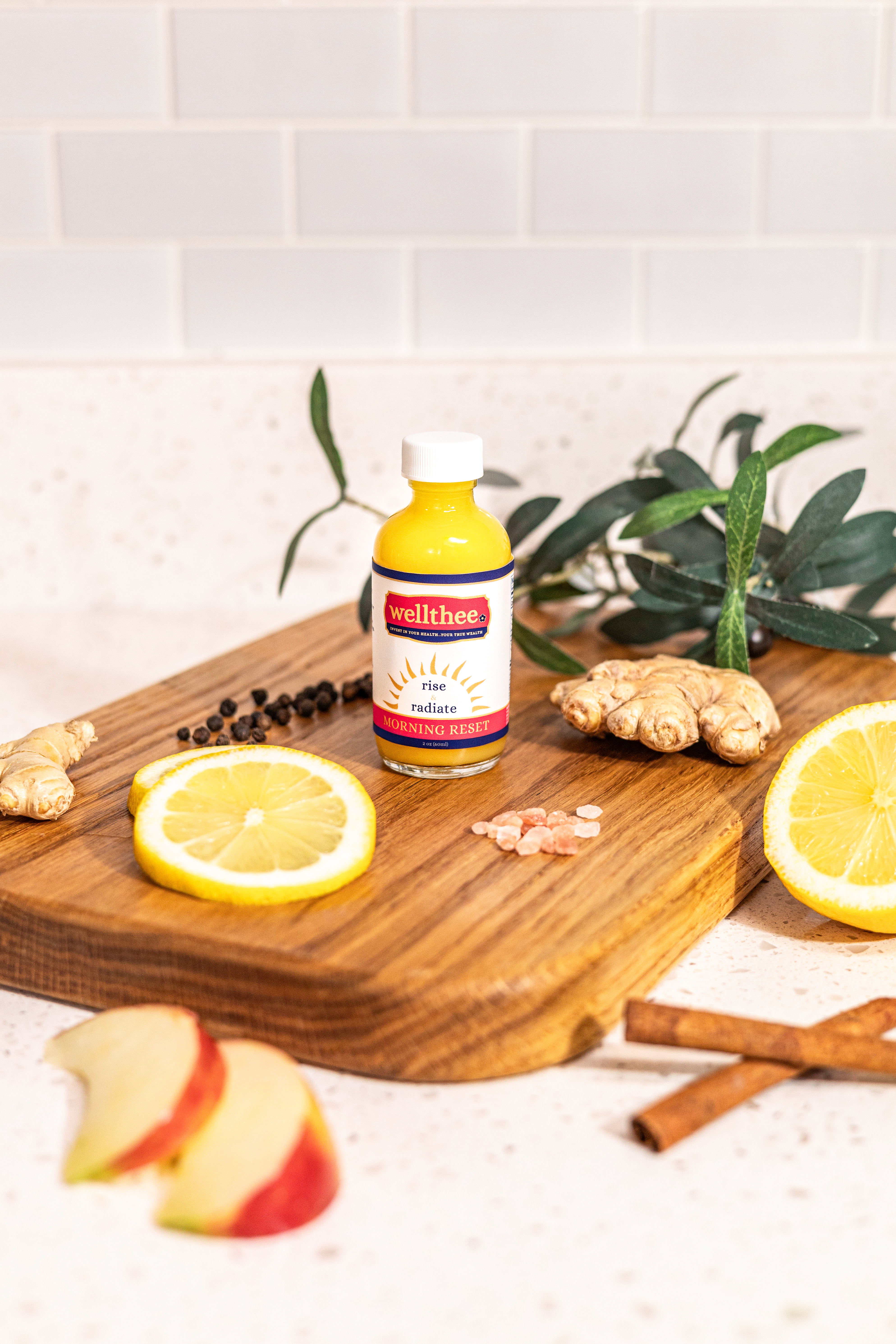 Bright countertop scene emphasizes whole-food ingredients and convenient daily cleanse in a single bottle.