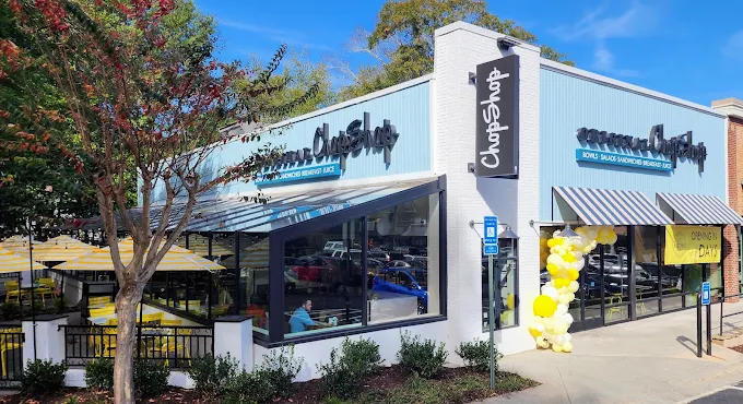 Exterior of Original ChopShop Buckhead Atlanta with blue accents and street view.