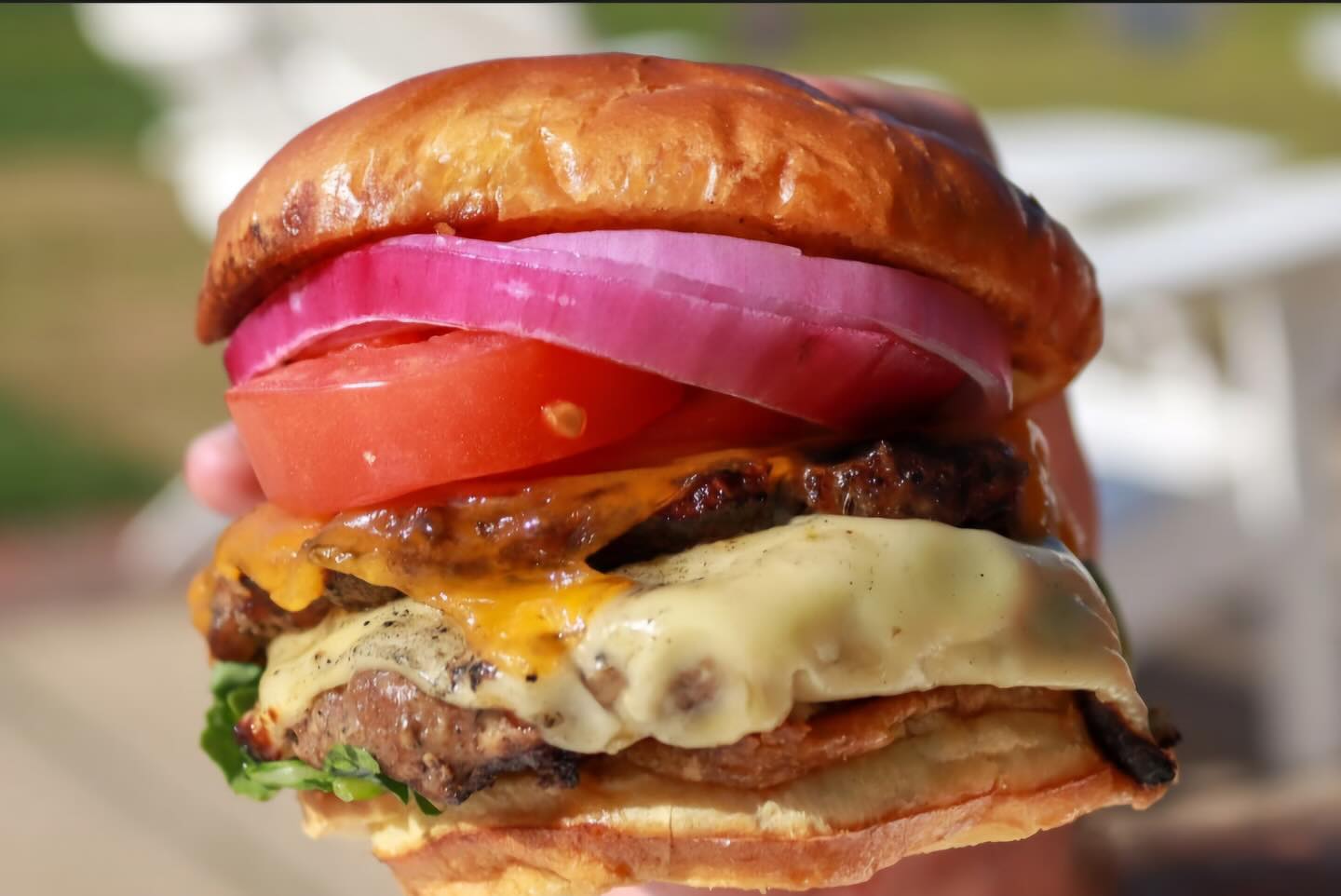 Close-up of a stacked smash burger at Chiringa Old Fourth Ward