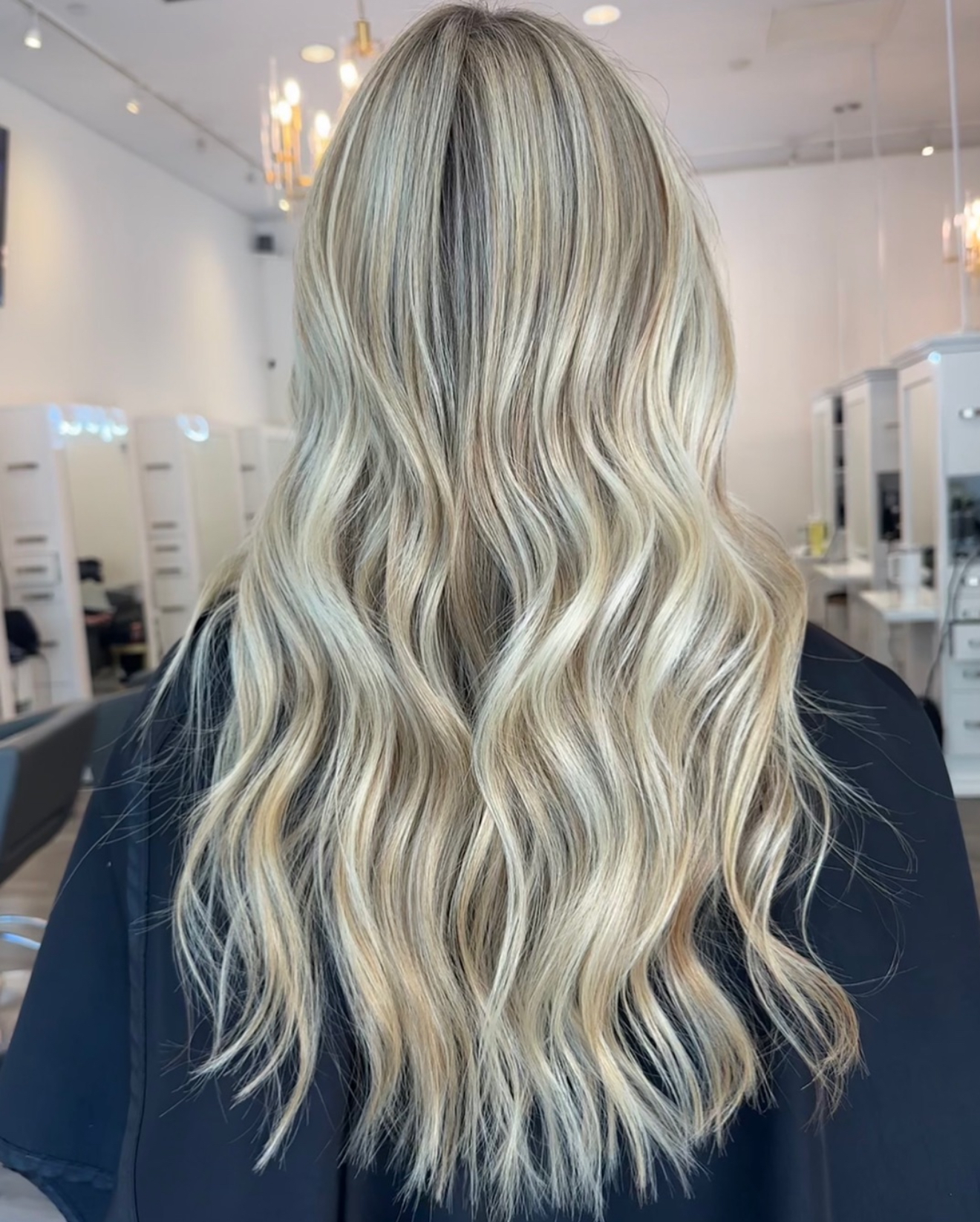 Back view of long platinum blonde waves styled at J Gold Salon Atlanta.