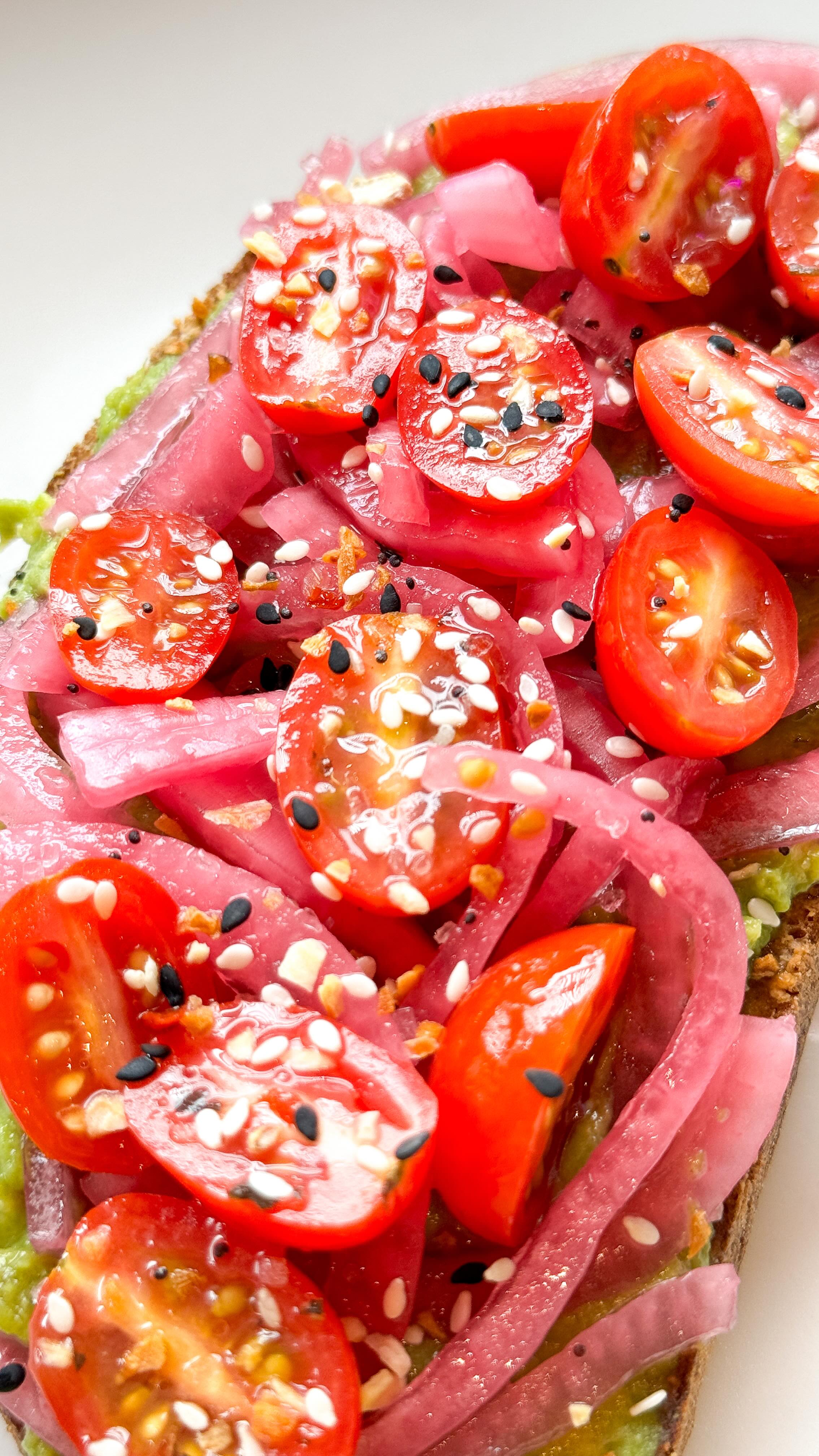 Overhead of berry-topped toast with powdered sugar and honey drizzle.