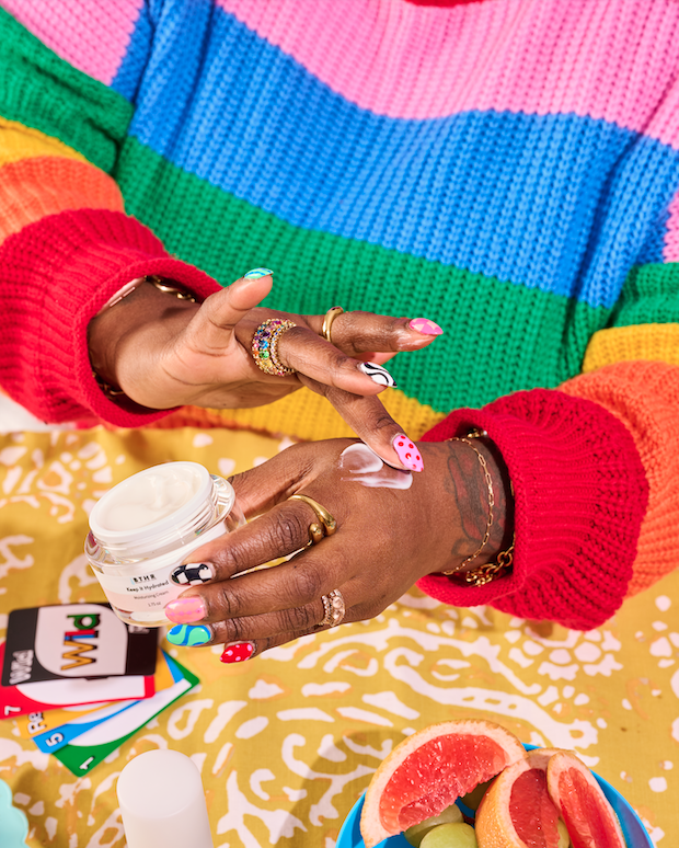 Flat lay of BTHR Keep It Hydrated Moisturizing Cream on a colorful knit sweater
