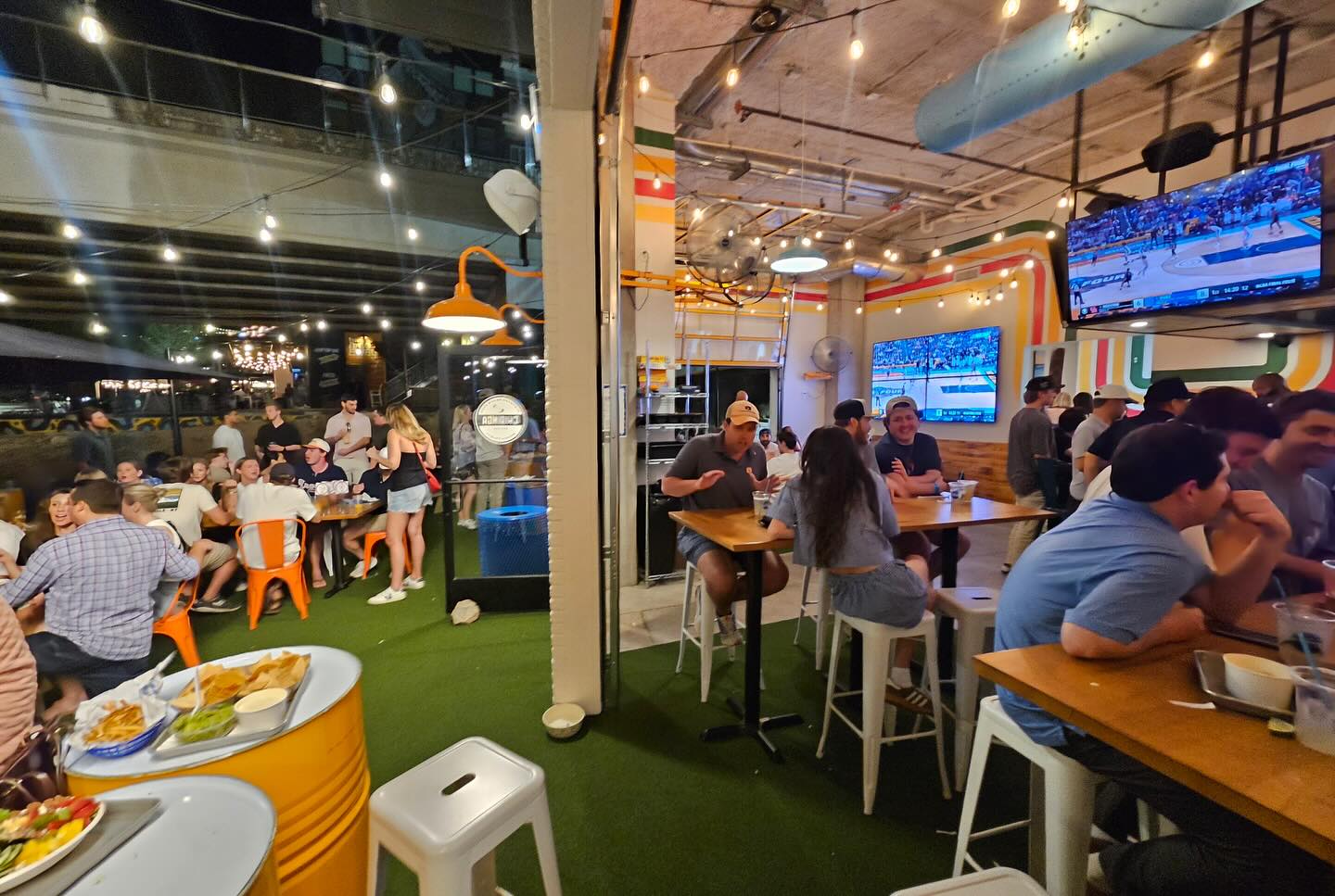 Packed dining room and bar scene at Chiringa Old Fourth Ward at night