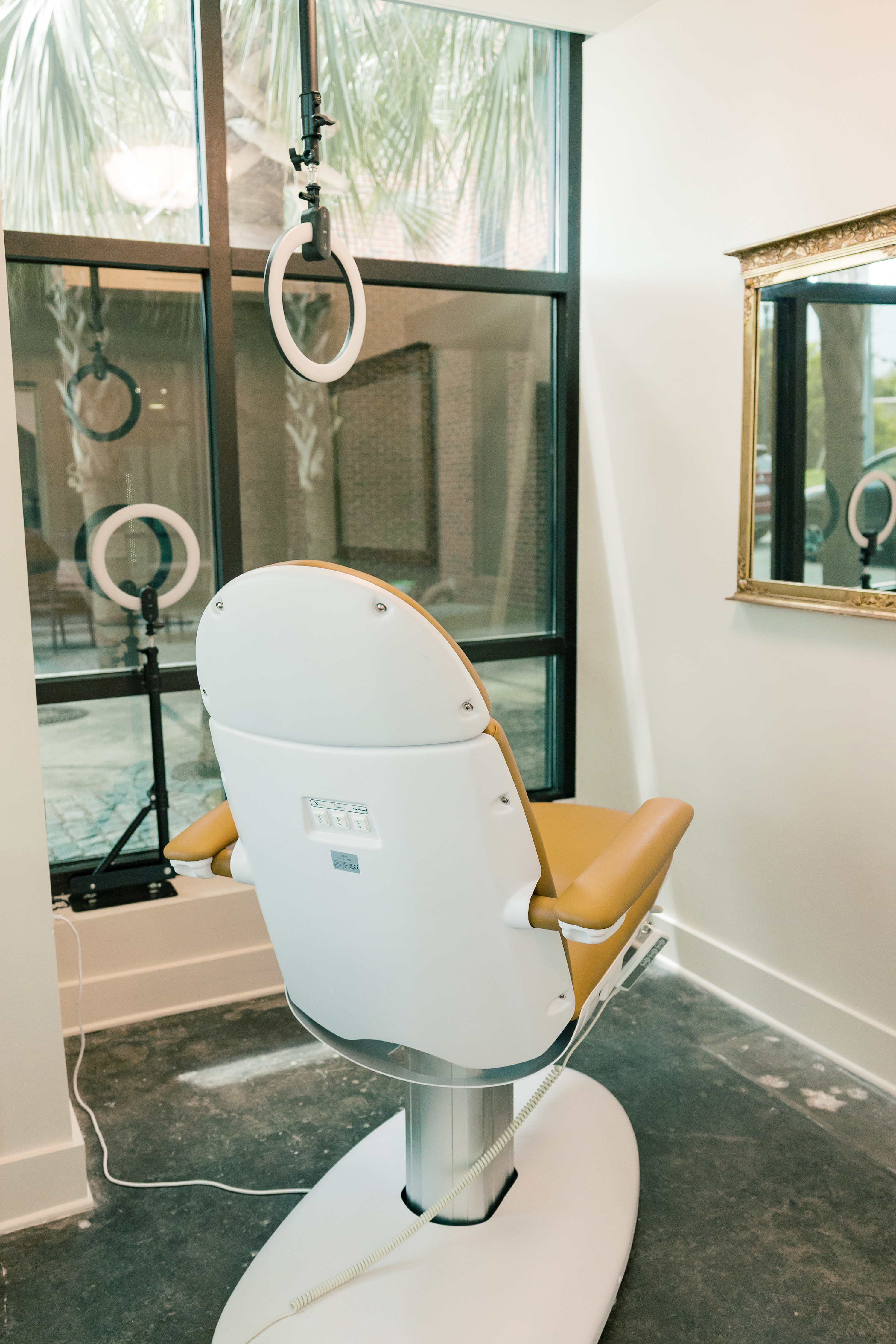 Modern treatment chair and equipment in a room at Pearl Medspa Charleston.