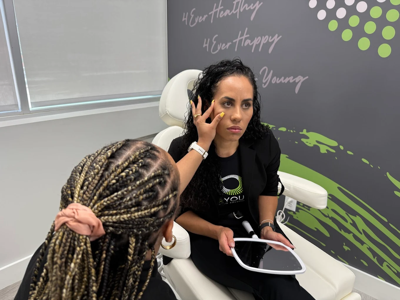 Provider discussing options with a seated client while referencing a tablet.
