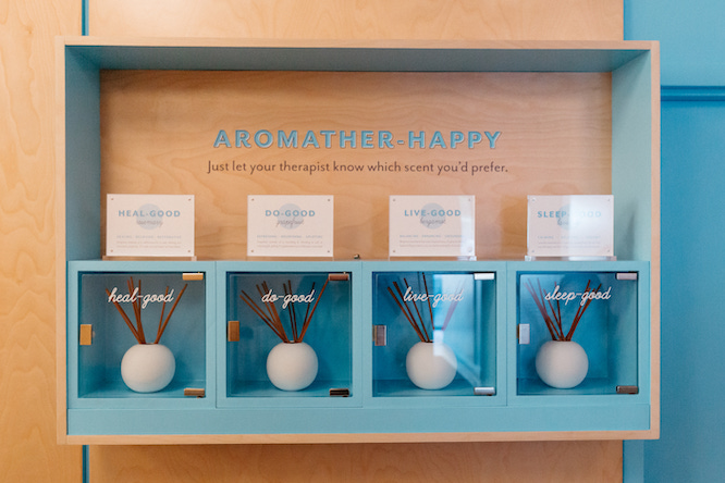 Turquoise aromatherapy display with four scent bottles inside Squeeze Midtown Atlanta Colony Square.