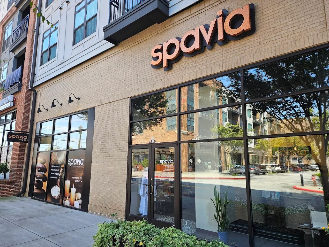 Street-view of Spavia Day Spa Chamblee storefront with brick exterior and large windows.