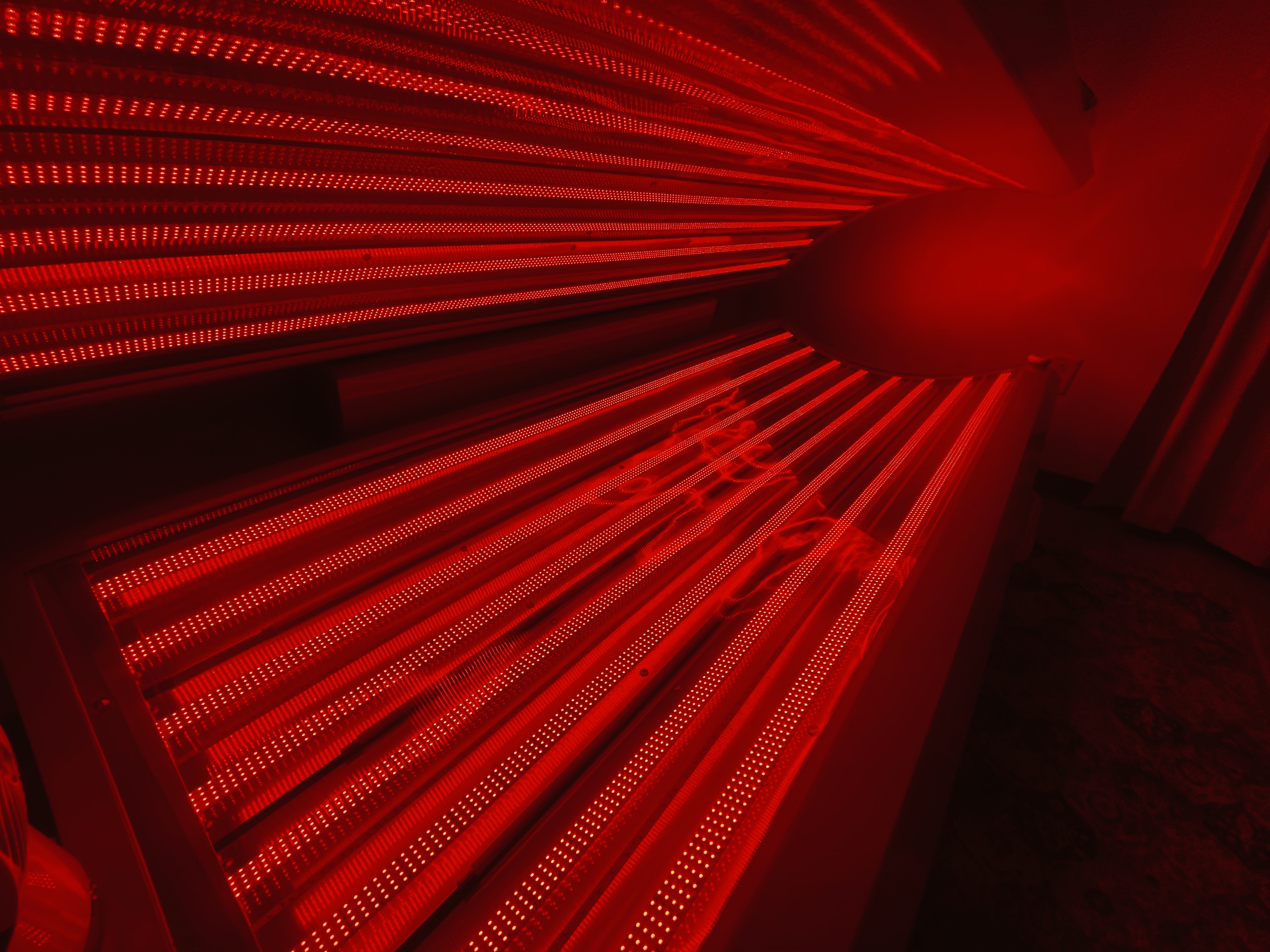 Glowing red-light therapy bed in recovery room at Modern Chiropractic Johns Island Charleston