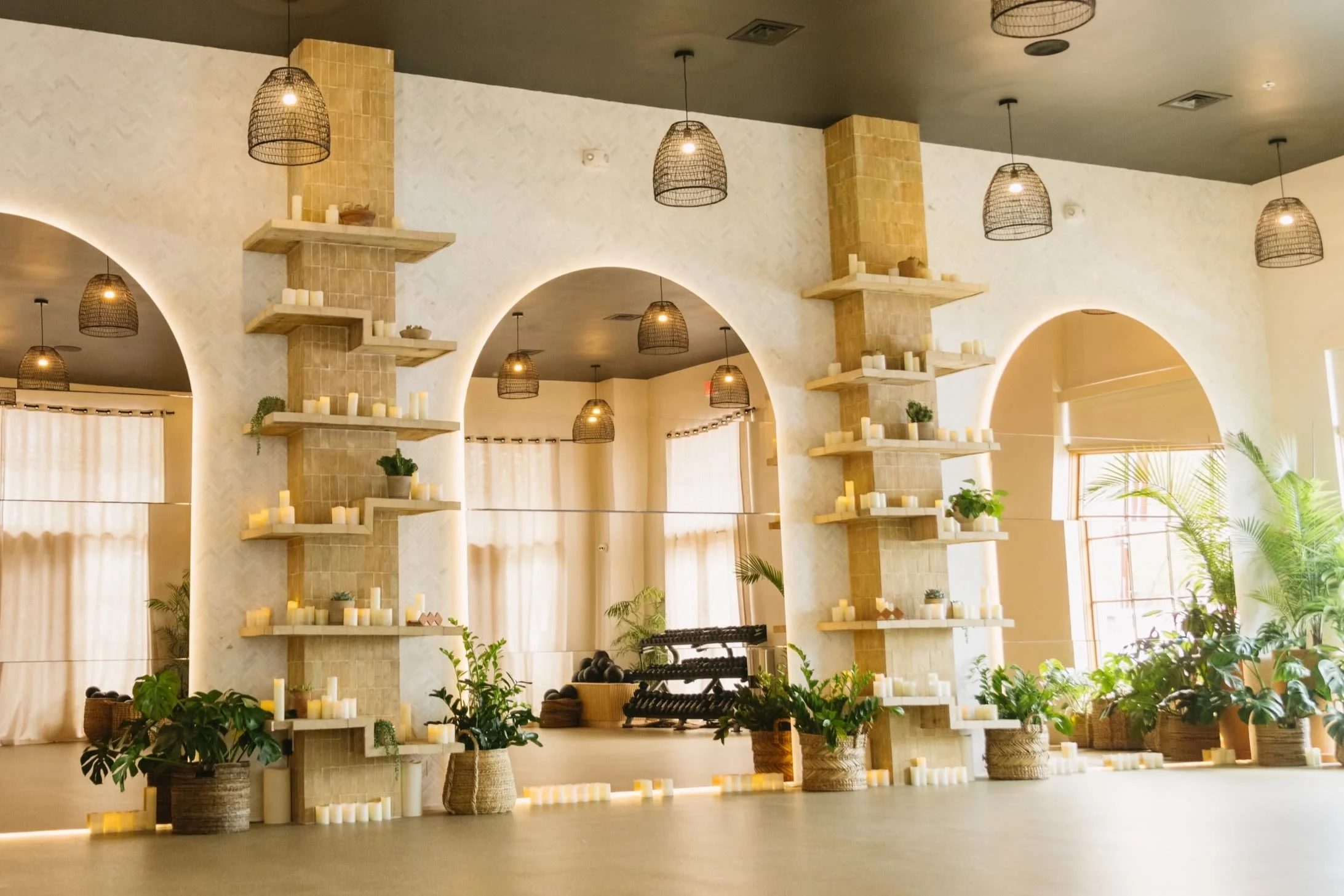 Jungle Studio Dallas interior with arched walls and greenery