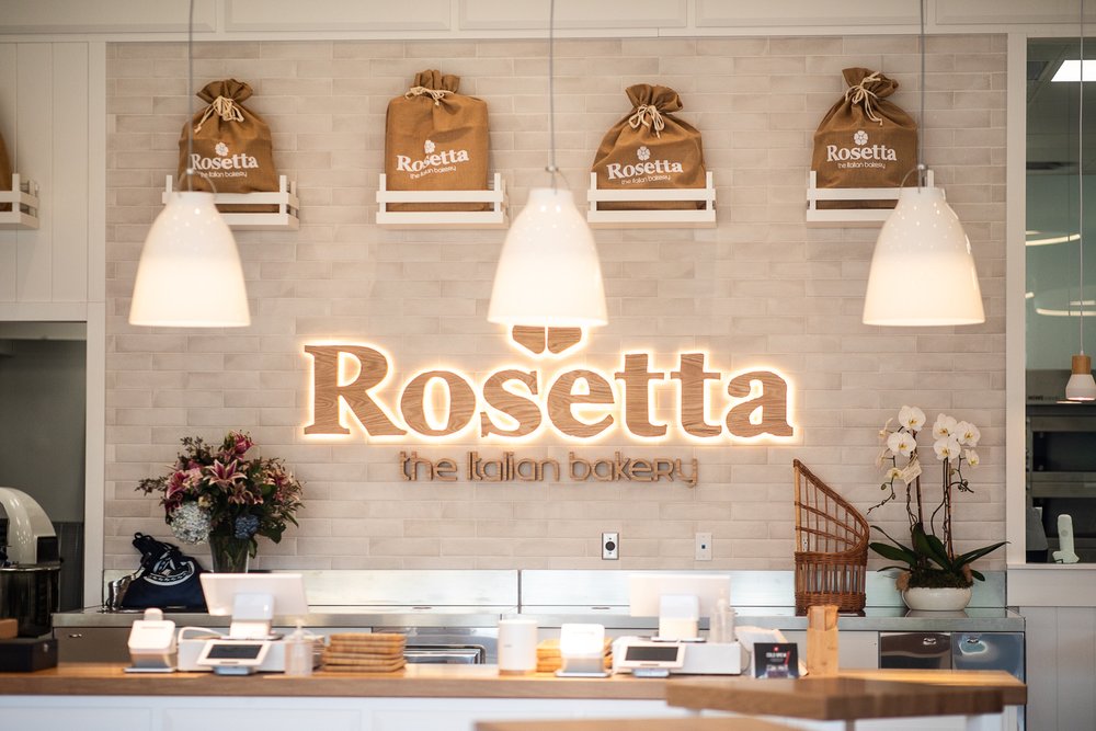 Rosetta Bakery interior with signature sign and bread display.