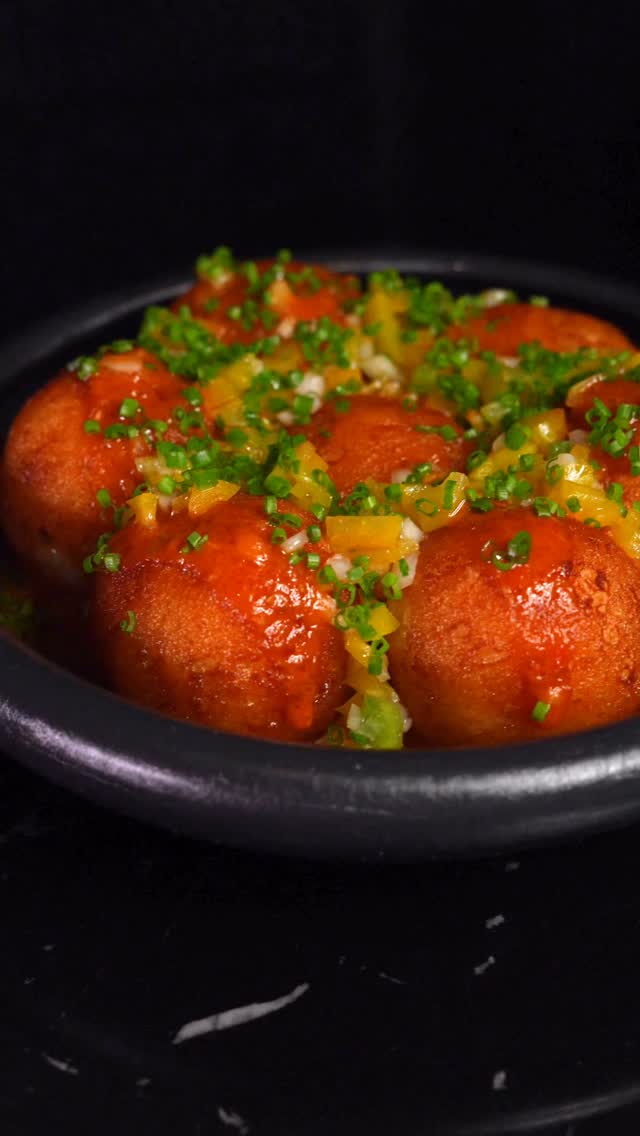 Bowl of saucy meatballs topped with herbs at Beso Buckhead Atlanta.
