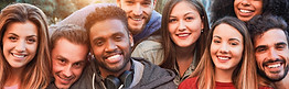 Happy millennial friends from diverse cultures and races having fun posing in front of sma