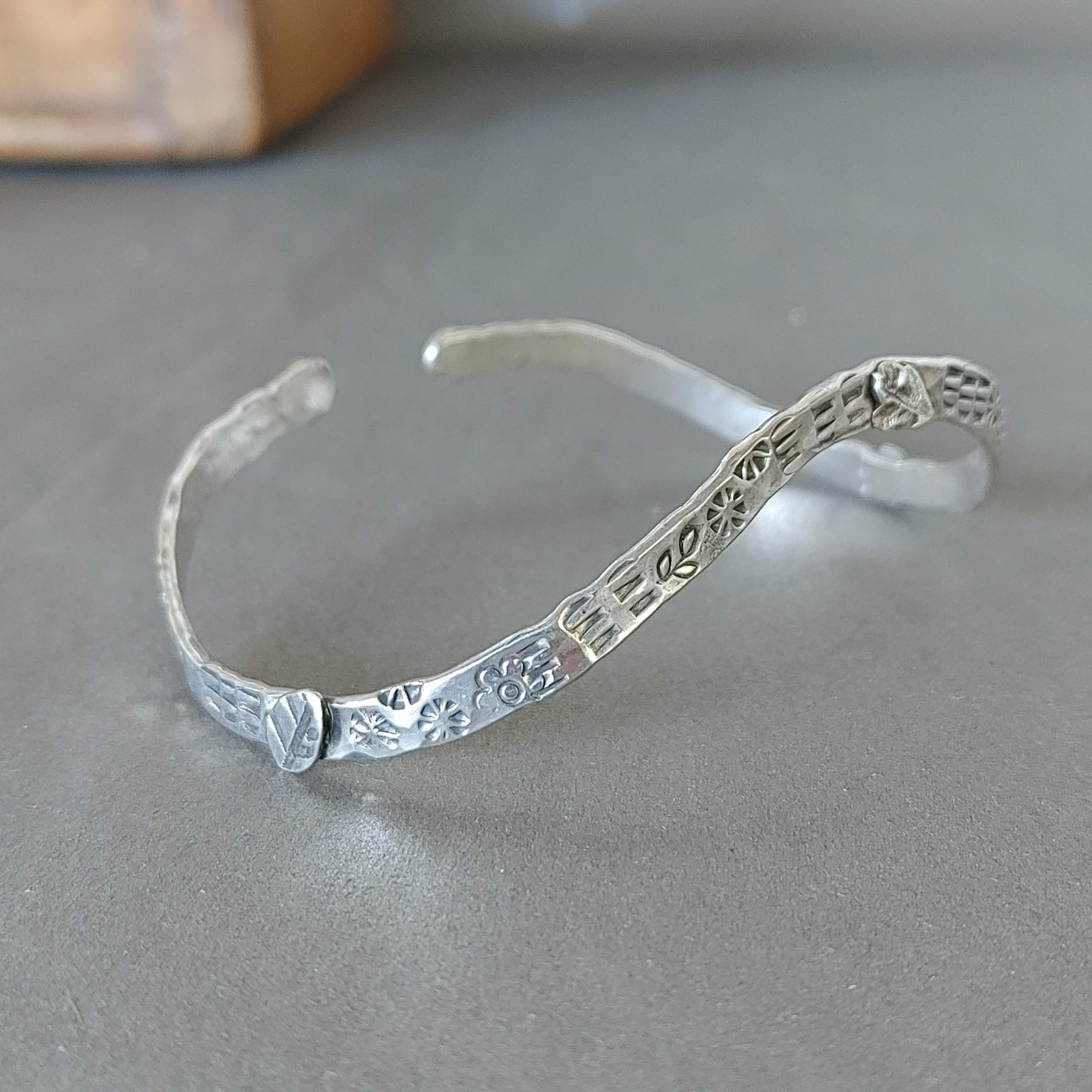 Hammered cuff with leaf and stamped accents