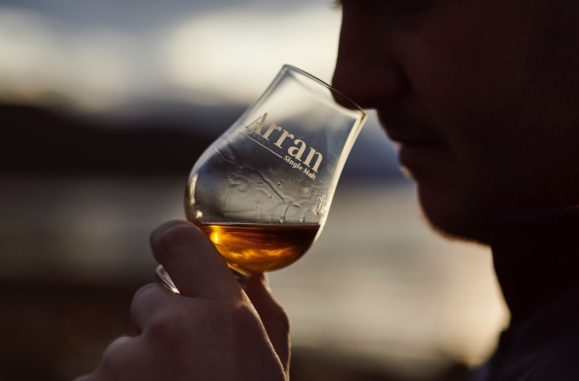 Man drinking Arran Single Malt whisky made at Lochranza Distillery