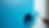 Close-up of paint roller applying vibrant blue paint on wall