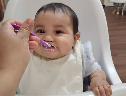 Infant being fed