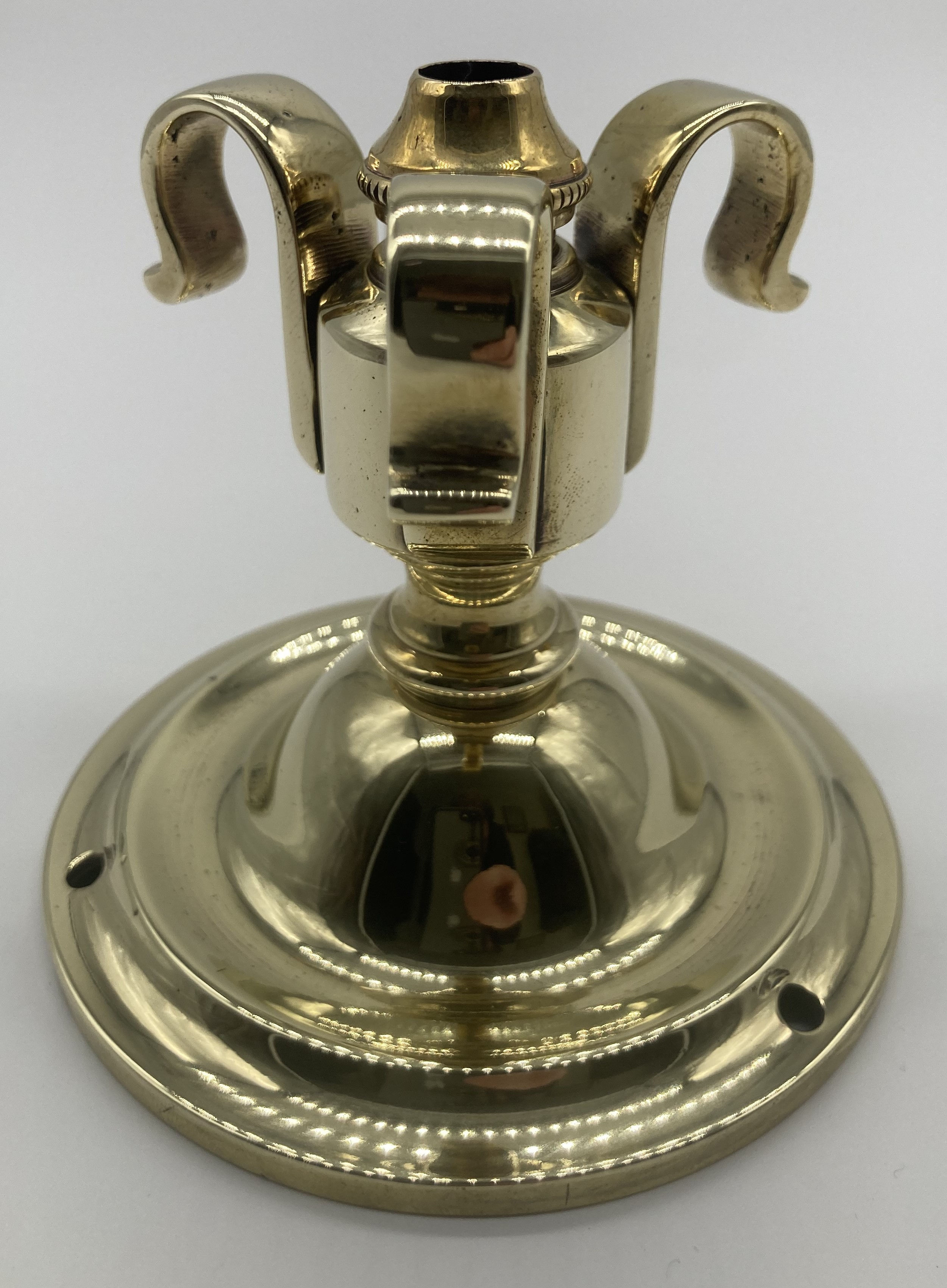 An Edwardian brass ceiling rose with triple hook