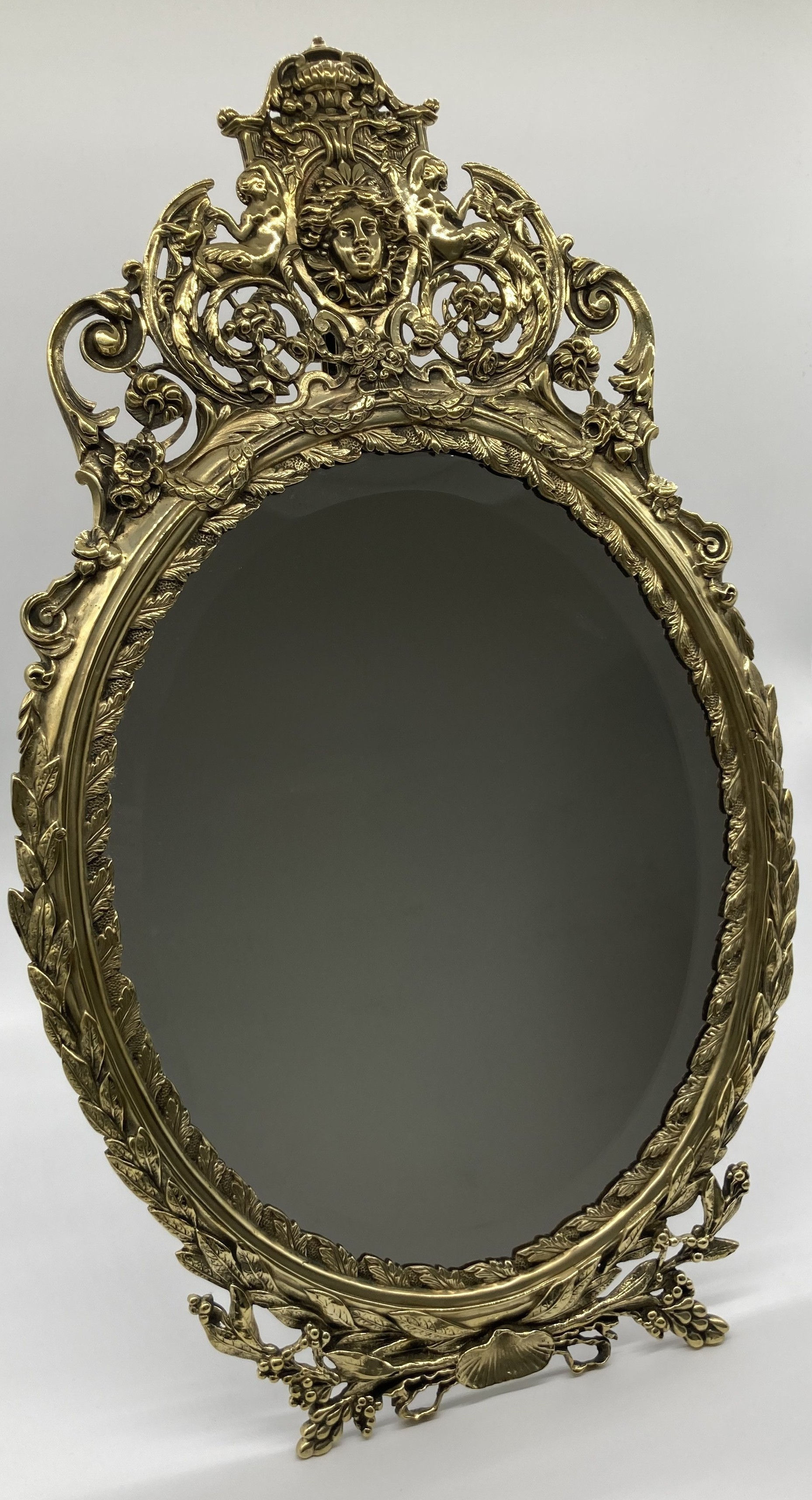 A late 19th Century neo - Classical style oval mirror
