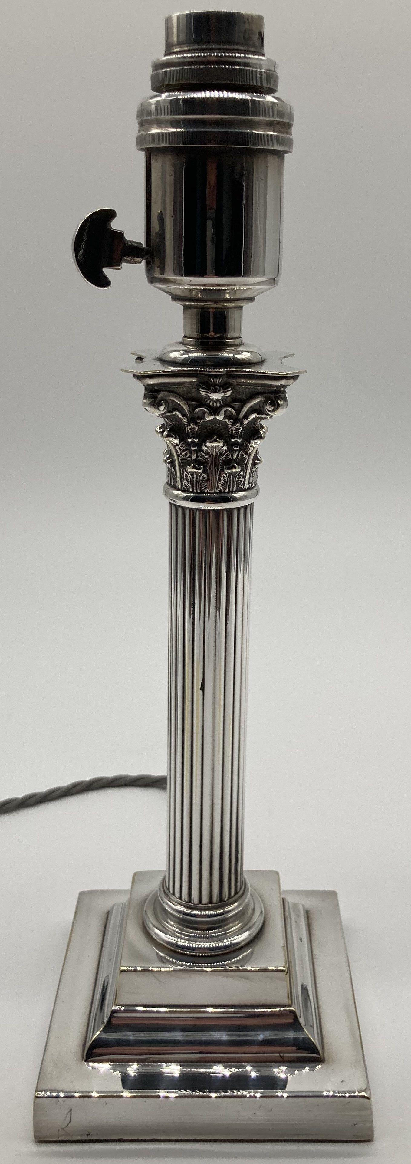An Edwardian small silver plated Corinthian column lamp