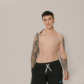 Model wearing Unity Cove gender-inclusive swimwear designed for comfort, coverage, and everyday movement | She Comes With Baggage Media