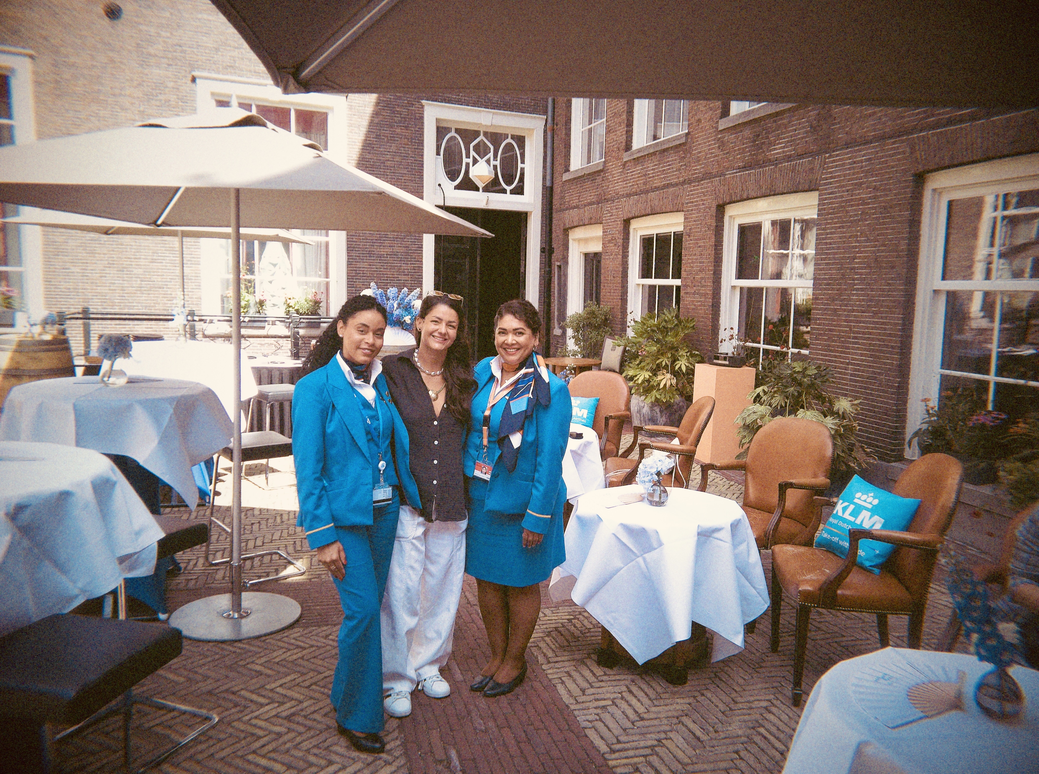 Founder of SCWB Media Kirstie Nicole and KLM Attendants at Pride House - Discover how KLM celebrated WorldPride Amsterdam 2026 through its Pride House, Canal Parade boat, Pride flights and LGBTQI+ inclusion initiatives | She Comes With Baggage Media