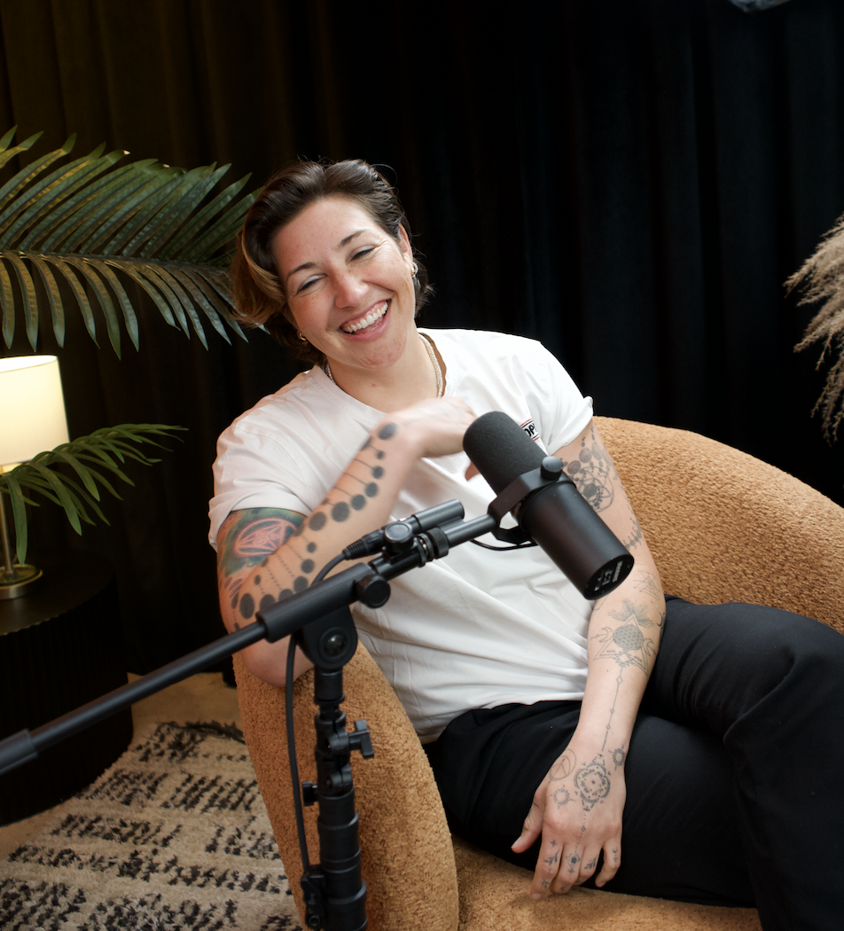 Portrait of Kelly Balch smiling, representing queer identity and resilience on She Comes With Baggage Podcast