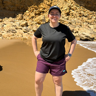 Model wearing Unity Cove gender-inclusive swimwear designed for comfort, coverage, and everyday movement | She Comes With Baggage Media