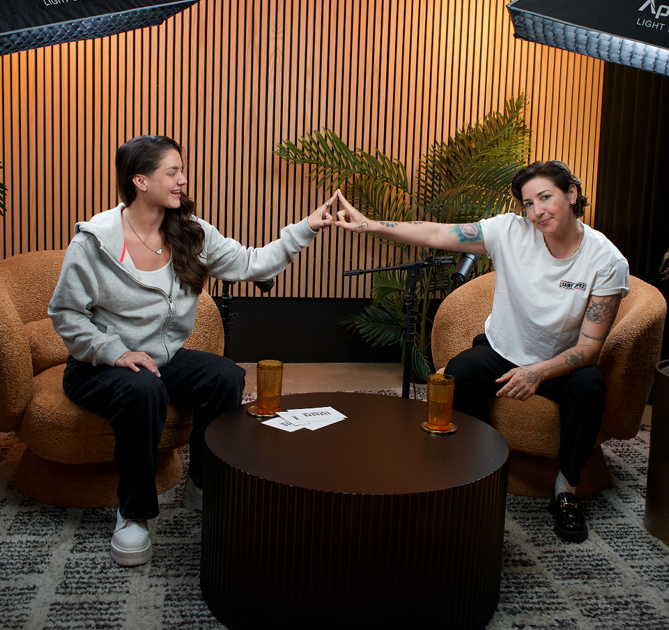 Portrait of Kelly Balch smiling, representing queer identity and resilience on She Comes With Baggage Podcast