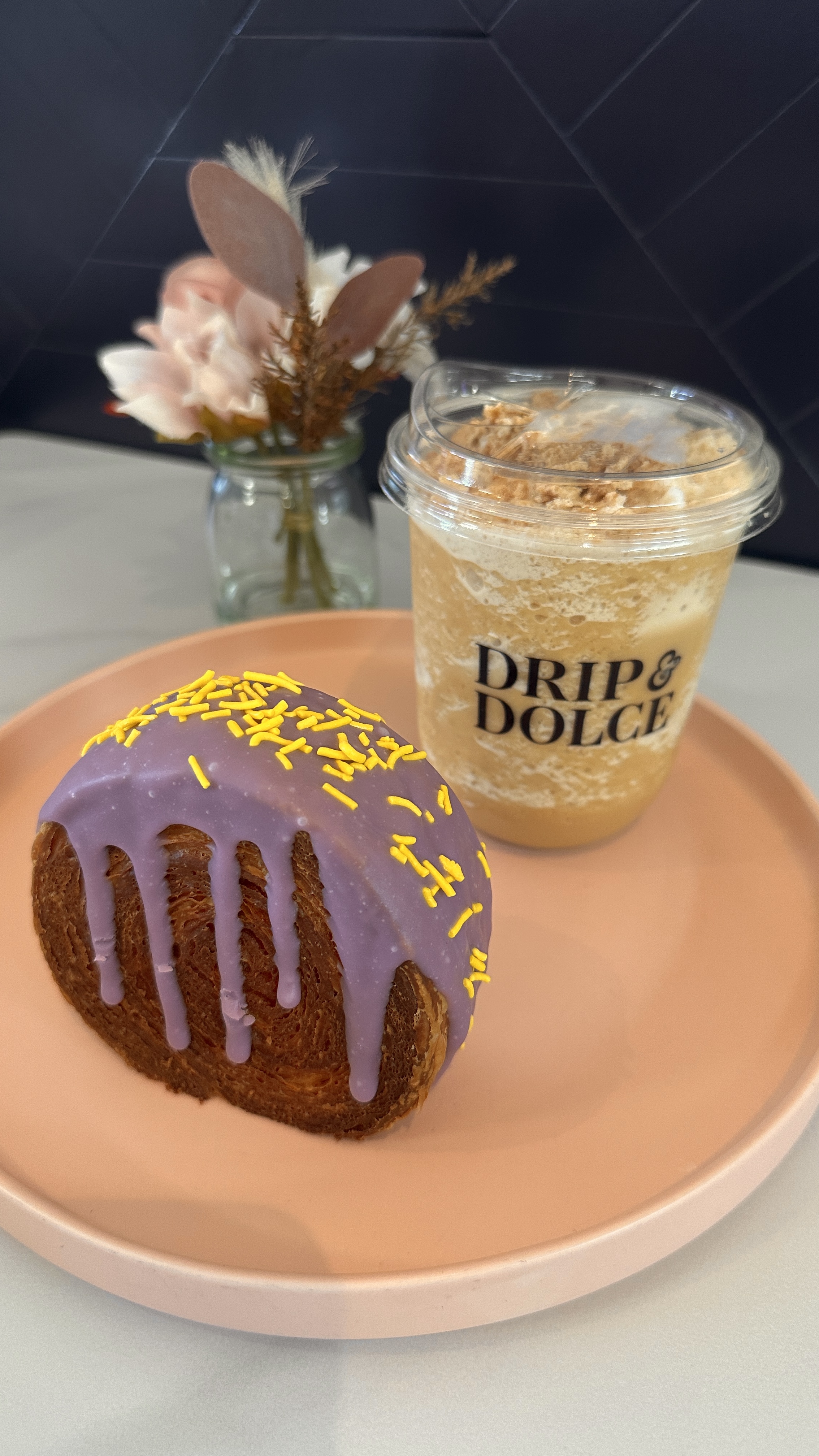 Signature latte and couture croissant at Drip & Dolce, a queer-owned café in West Hollywood, and a beautifully presented latte croissant combination
