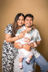 Family photoshoot Singapore studio parents holding baby portrait session