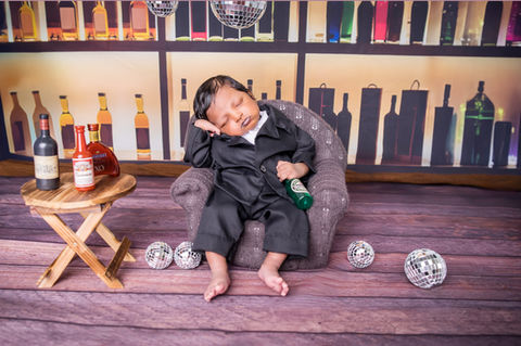Newborn photoshoot Singapore themed setup baby sleeping in studio with props