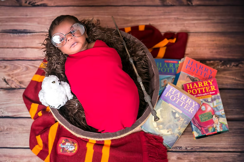 newborn baby in harry potter themed photoshoot singapore with wizard wraps, custom props like books and wands