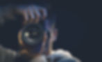 a-man-photographer-with-a-camera-takes-a-photo-in-the-dark-copy-space--e1647922080119.jpg