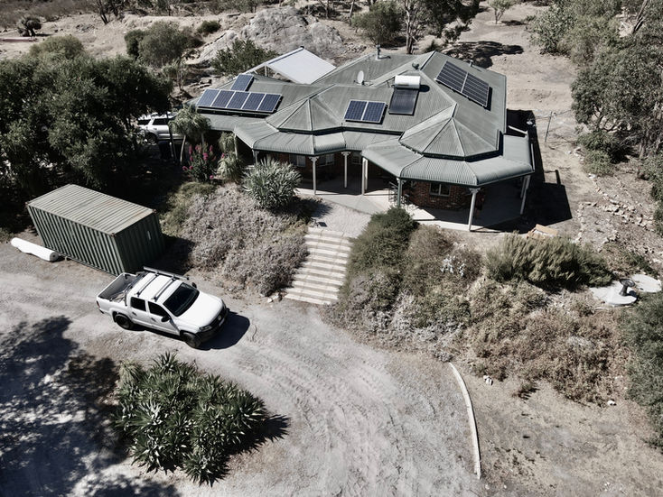 Natural pool and garden design for Perth Hills of native planting by YLA Studio Yoxall landscape architecture with sunken fireplace and built in seating 