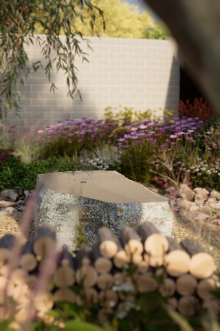 a large rock sits in the middle of a garden