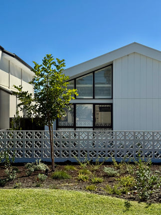 a white house with a tree in front of it