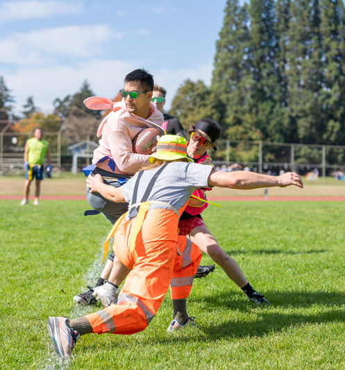 People playing a game on a grassy field.