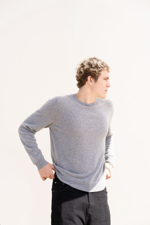 Person in gray sweater looking to the side.