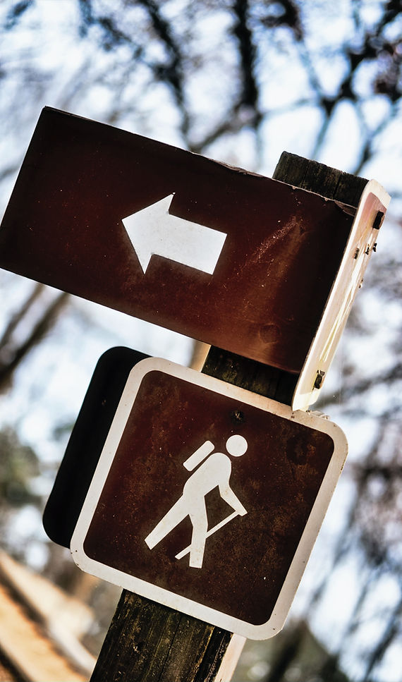 Hiking sign with arrows on trail_edited.
