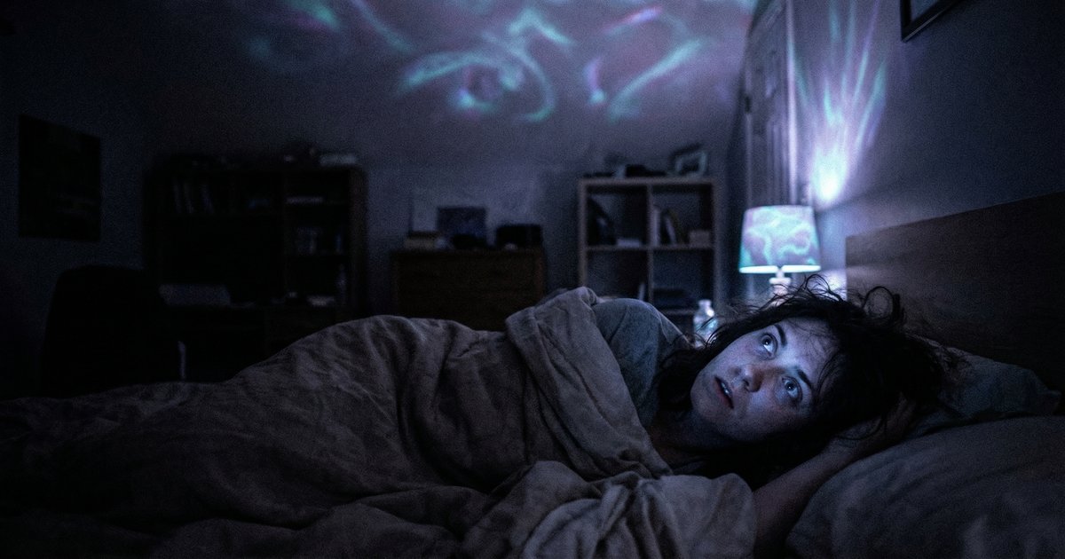 Person lying awake at night experiencing a 5-MeO-DMT reactivation