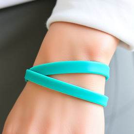 teal rubber smooth flat band bracelet on a wrist.jpg