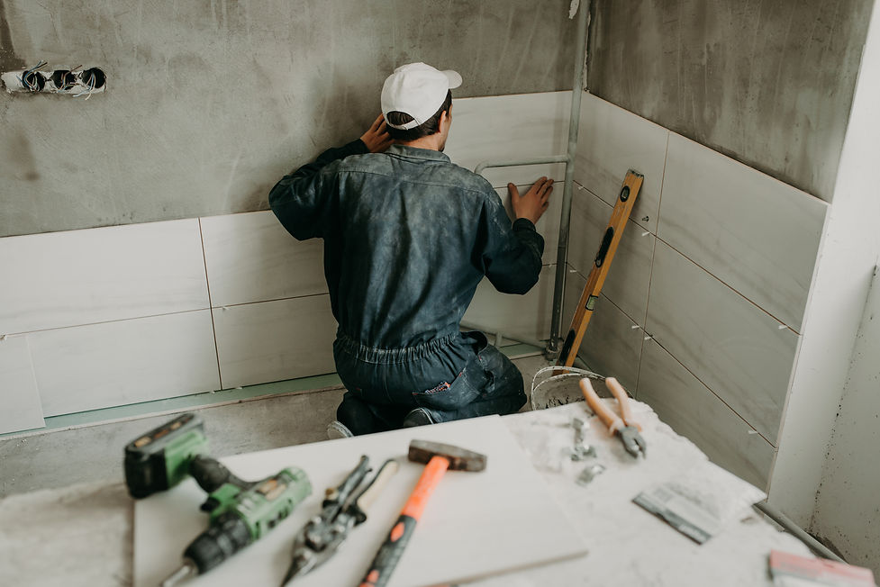 worker-repairman-puts-large-ceramic-tiles.jpg